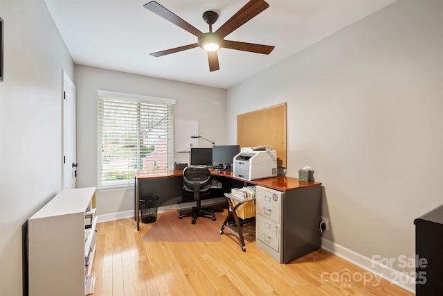 office space featuring light wood-type flooring, baseboards, and a ceiling fan