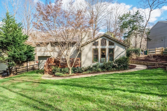 exterior space featuring fence, a deck, and a lawn