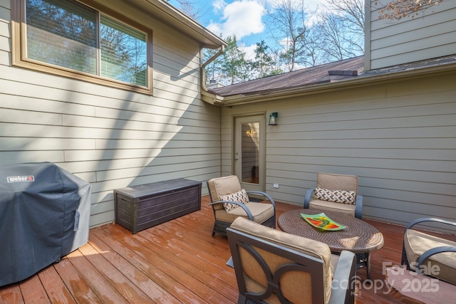 wooden deck with a grill