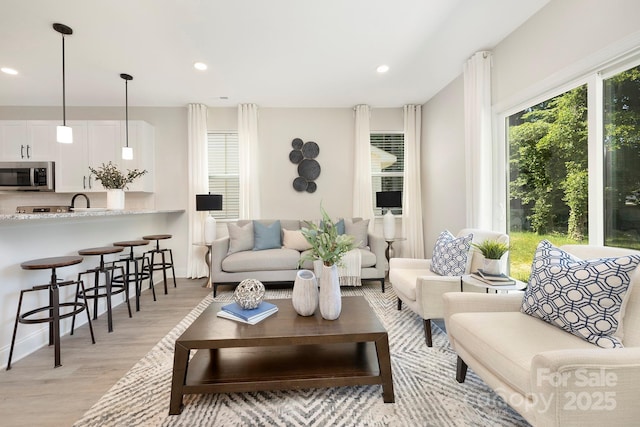 living room featuring light wood-style flooring and recessed lighting