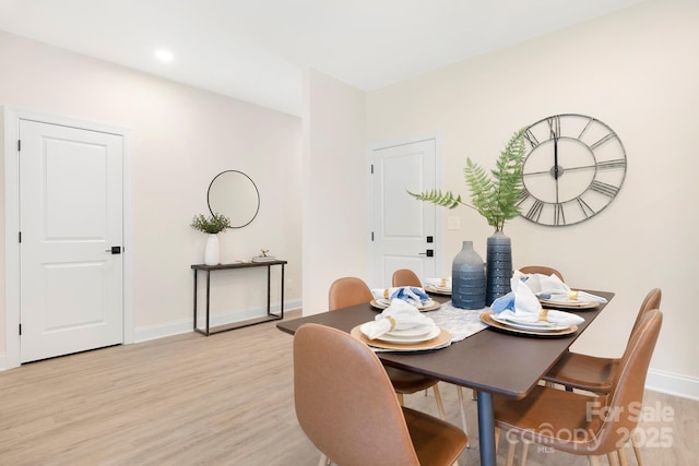 dining room featuring light wood finished floors, baseboards, and recessed lighting