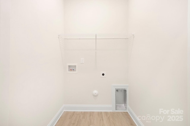 clothes washing area featuring laundry area, gas dryer hookup, wood finished floors, hookup for a washing machine, and electric dryer hookup