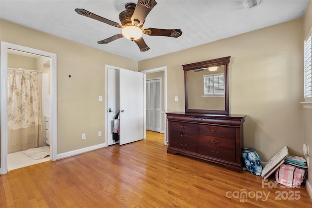 unfurnished bedroom featuring light wood-type flooring, visible vents, ensuite bathroom, baseboards, and ceiling fan