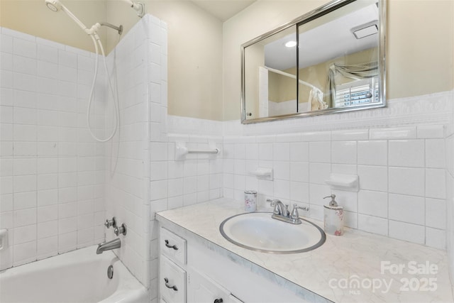 bathroom with vanity, tub / shower combination, and wainscoting