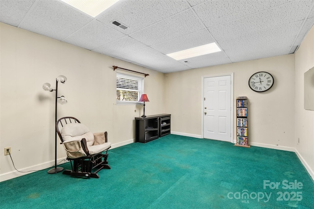 sitting room featuring visible vents, baseboards, a paneled ceiling, and carpet