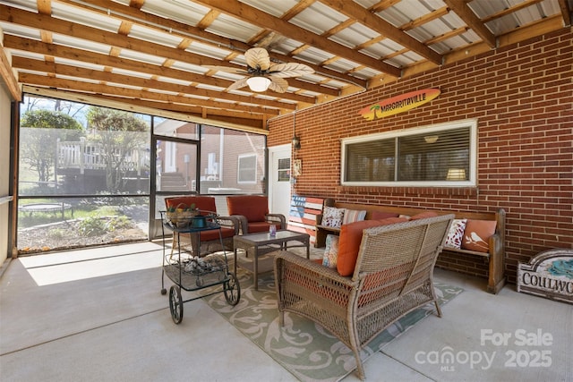 sunroom / solarium featuring a ceiling fan