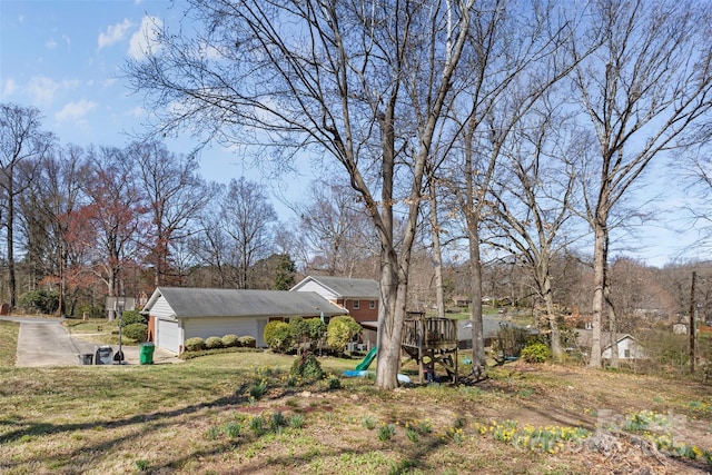 view of yard with a garage and a playground