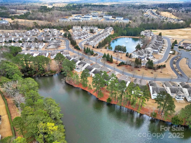 birds eye view of property featuring a water view and a residential view