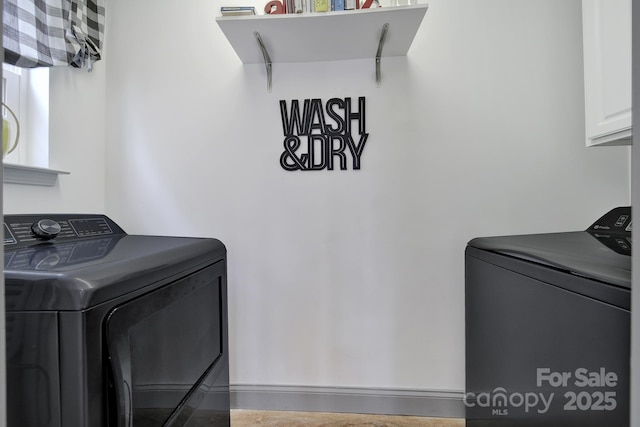 laundry room with cabinet space and separate washer and dryer