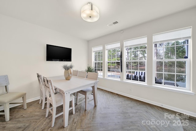 dining room featuring visible vents and baseboards