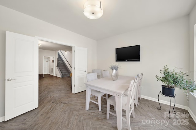 dining room with stairs and baseboards