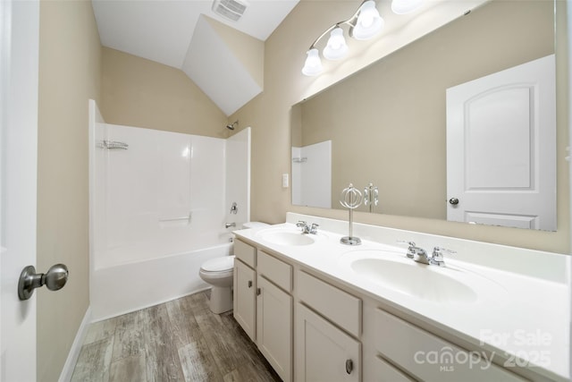 bathroom with wood finished floors, visible vents, a sink, and shower / bathtub combination