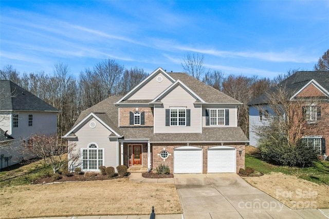 traditional home featuring a garage, concrete driveway, roof with shingles, a front lawn, and brick siding