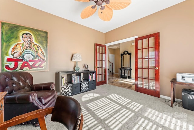 living area featuring french doors, carpet flooring, a ceiling fan, and baseboards