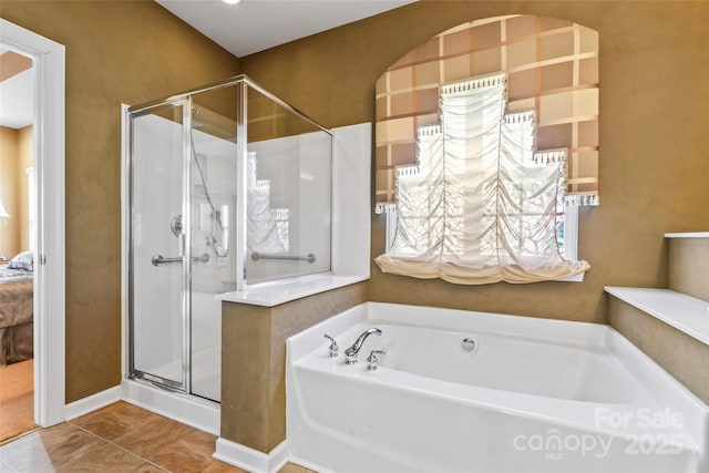 full bath featuring a shower stall, a bath, and ensuite bathroom