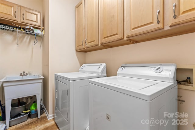 laundry room featuring washing machine and dryer and cabinet space