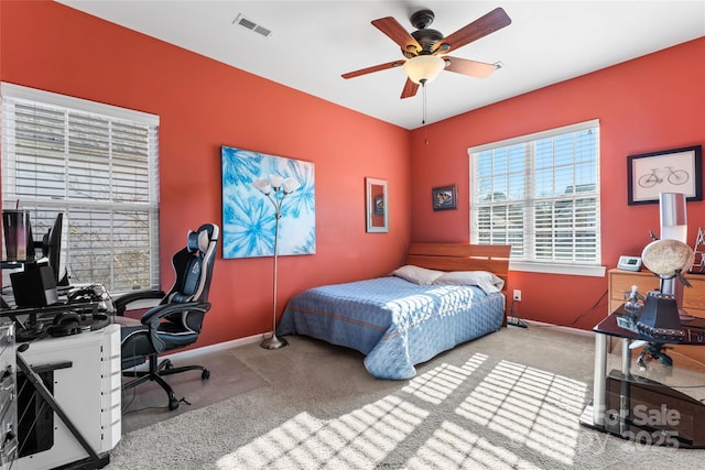 carpeted bedroom featuring visible vents, ceiling fan, and baseboards