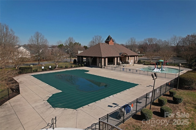 community pool featuring fence and a patio