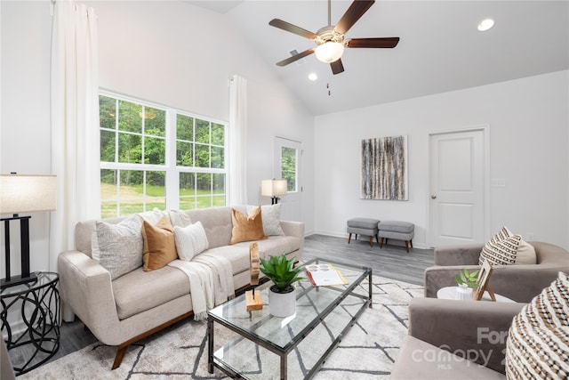 living area with baseboards, a ceiling fan, light wood-type flooring, high vaulted ceiling, and recessed lighting