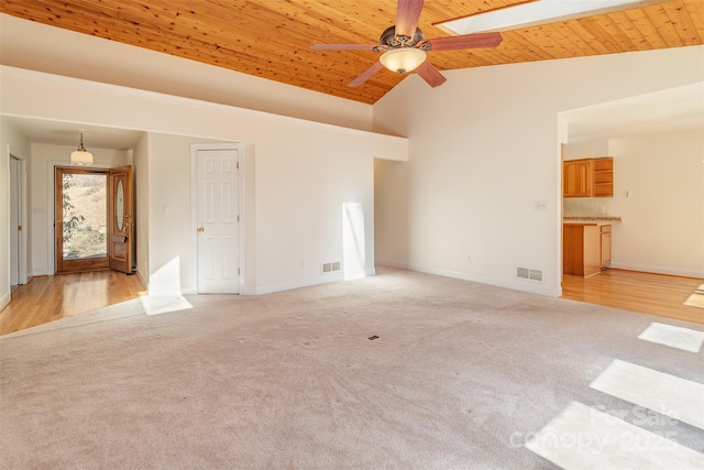 unfurnished living room with wood ceiling, light carpet, and visible vents