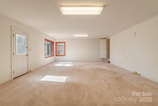 carpeted spare room with baseboards