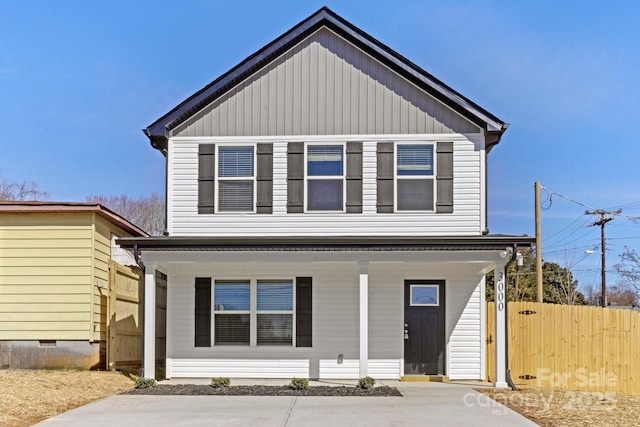 view of front of home featuring crawl space, fence, a porch, and board and batten siding