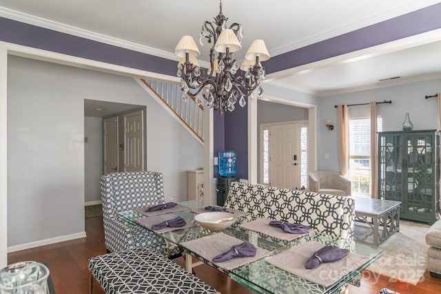 dining room with baseboards, a notable chandelier, ornamental molding, and wood finished floors