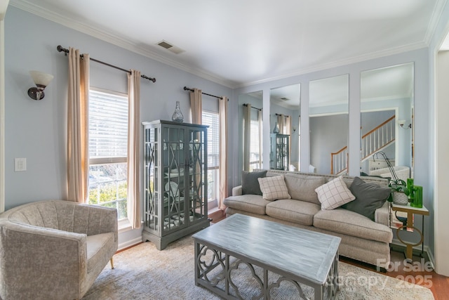 living area with stairs, ornamental molding, and visible vents