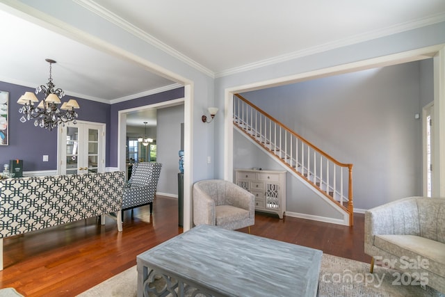 interior space featuring stairway, ornamental molding, wood finished floors, a chandelier, and baseboards