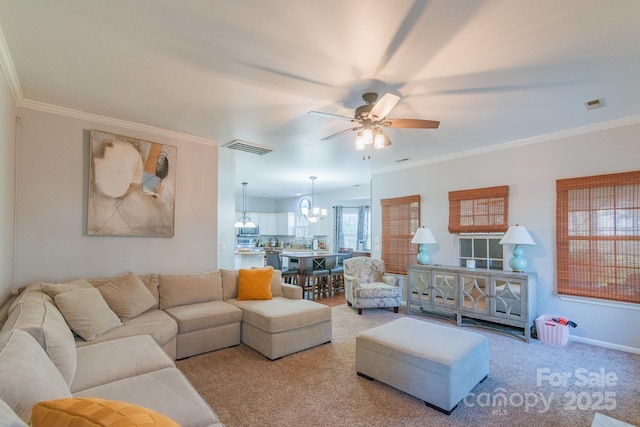 carpeted living room featuring ornamental molding, visible vents, baseboards, and ceiling fan with notable chandelier