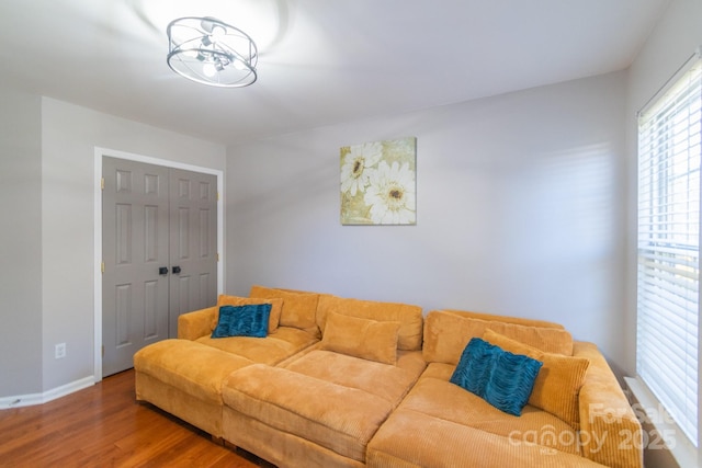 living area with wood finished floors and baseboards