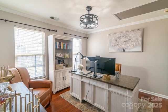 office area featuring attic access, visible vents, ornamental molding, and dark wood-type flooring