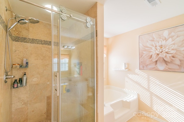 full bath with a stall shower, visible vents, and a garden tub