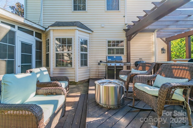 wooden deck with an outdoor hangout area, a grill, and a pergola