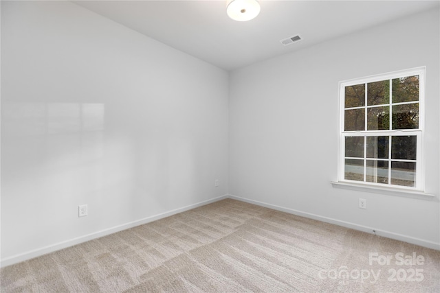 empty room with light carpet, baseboards, and visible vents