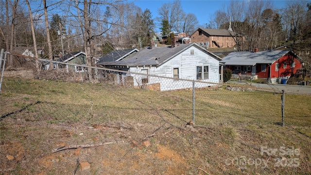 rear view of property with fence