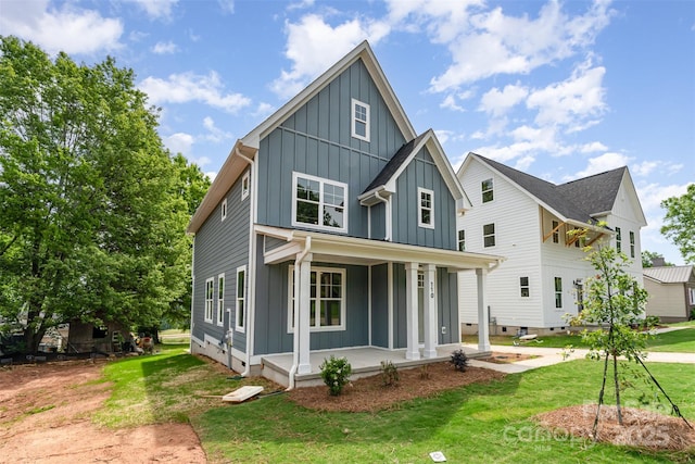 110 Walters St, Huntersville, NC 28078 - view of front facade with board and batten siding, a porch, and a front yard