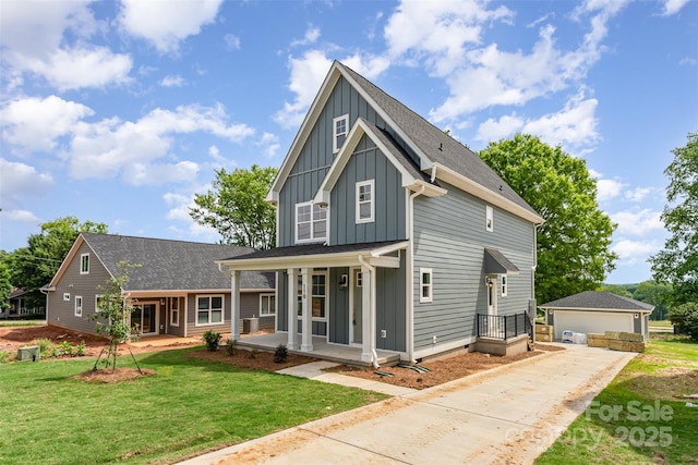 110 Walters St, Huntersville, NC 28078 - view of front of house featuring board and batten siding, a porch, a front lawn, and a garage