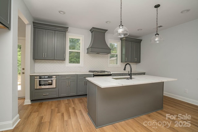 110 Walters St, Huntersville, NC 28078 - kitchen with custom range hood, stainless steel appliances, gray cabinets, a sink, and decorative backsplash
