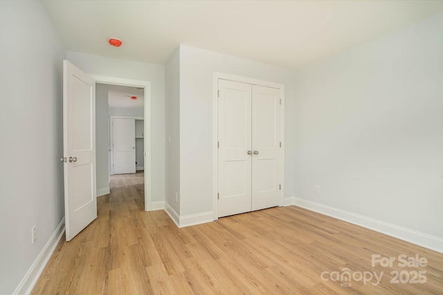 110 Walters St, Huntersville, NC 28078 - unfurnished bedroom featuring light wood-style flooring, baseboards, and a closet