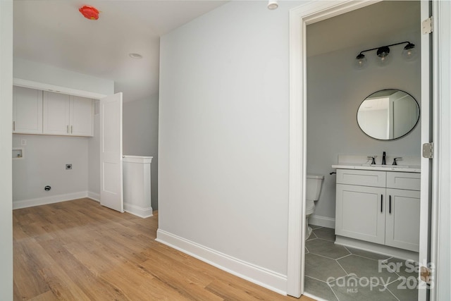 110 Walters St, Huntersville, NC 28078 - washroom featuring hookup for an electric dryer, a sink, light wood finished floors, and baseboards