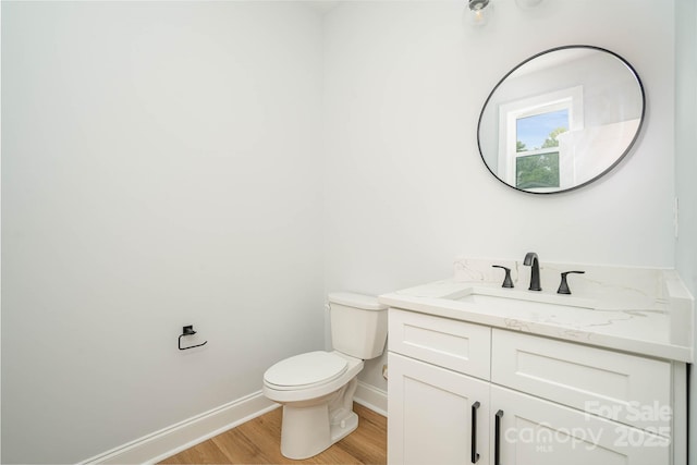 110 Walters St, Huntersville, NC 28078 - half bathroom featuring wood finished floors, toilet, baseboards, and vanity