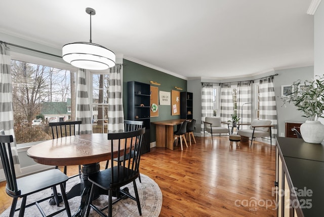 dining area featuring crown molding and wood finished floors