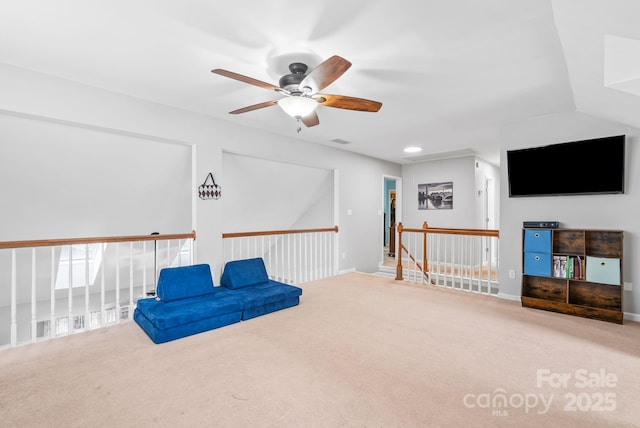 sitting room with recessed lighting, carpet flooring, visible vents, and an upstairs landing