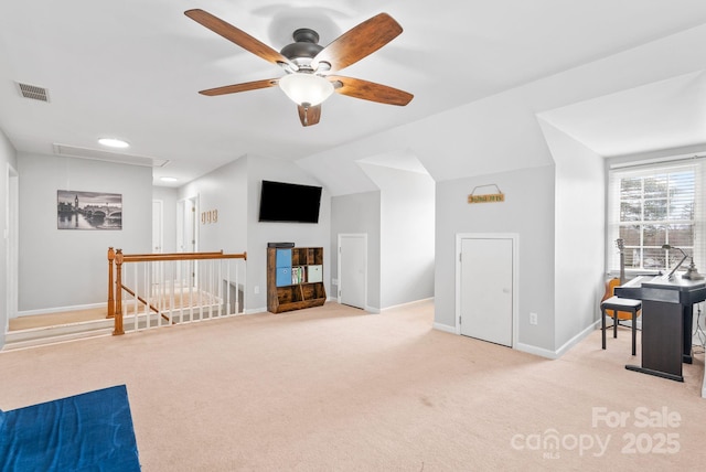 interior space with lofted ceiling, visible vents, attic access, carpet flooring, and baseboards