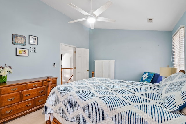 bedroom featuring vaulted ceiling, a ceiling fan, and light colored carpet