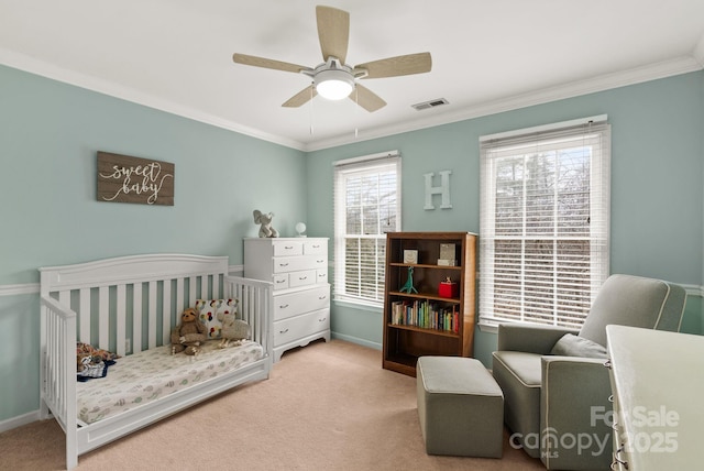 bedroom with a nursery area, ornamental molding, carpet flooring, and visible vents