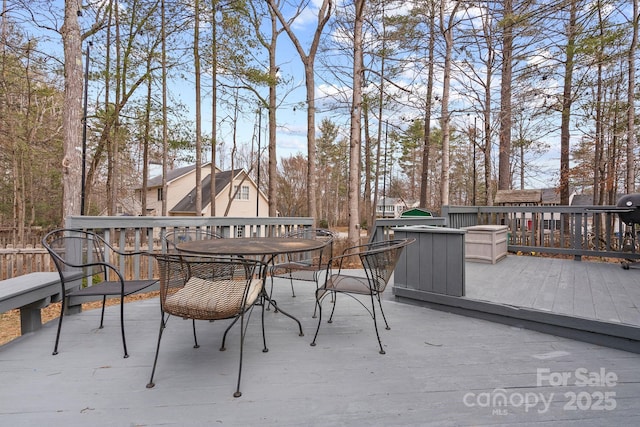 wooden terrace with outdoor dining area