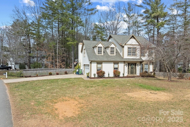 view of front of home with driveway, a garage, fence, and a front yard