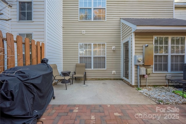 view of patio with grilling area and fence